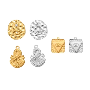 Detailed evil eye charms in gold and silver finish with zircon accents and small loop