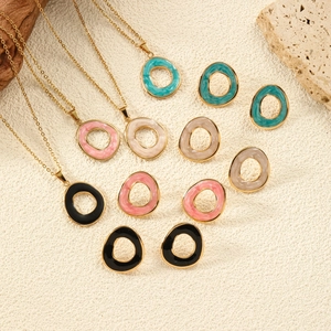 Minimalist titanium steel oval jewelry set with colorful enamel glaze on a textured background