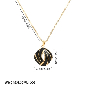 Detail view of square black enamel pendant with gold spiral stripes and measurements