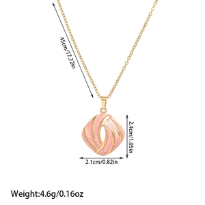 Detail view of pink enamel square pendant necklace with gold spiral pattern and dimensions