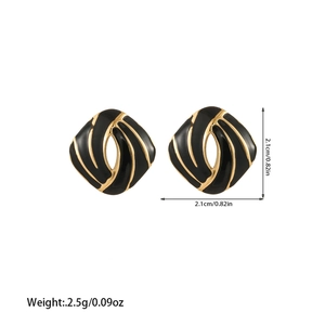 Detailed view of geometric black enamel earrings with gold streamline design 2.1cm