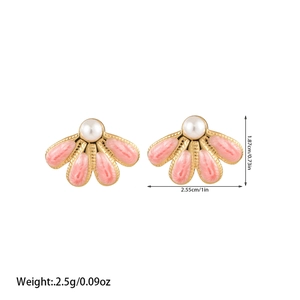 Detailed view of fan-shaped pink enamel earrings with white pearls and gold-plated base