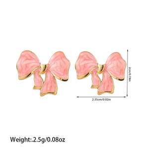 Detail view of pink bow earrings with golden metal edges and exact size measurements