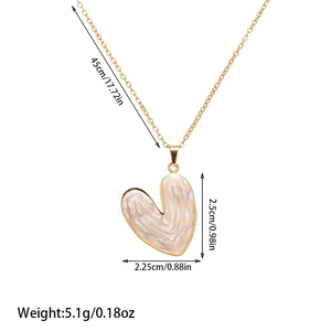 Detail view of gold heart necklace with cream marble texture and size measurements