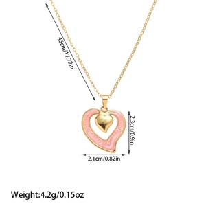 Detailed view of nested heart pendant with pink enamel finish and 45cm gold chain