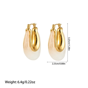Detail view of U-shaped gold earrings with cream marble resin charms and exact measurements