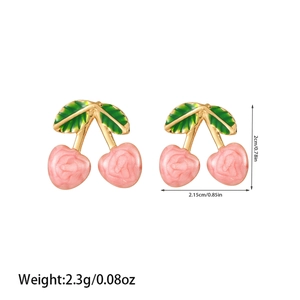 Detail view of pink cherry earrings with rose texture and green enamel leaves