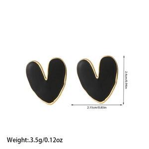 Detail showing asymmetric heart-shaped black enamel earrings with golden borders and sizes