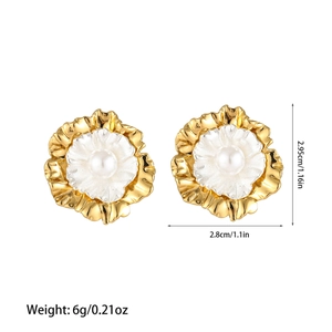 Detailed view of U-shaped flower earrings with golden petals and pearl center