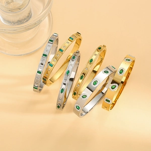 Polished titanium steel bracelets with vibrant green emerald stones in gold and silver finish