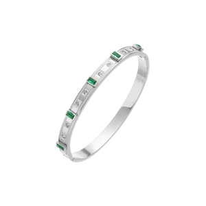 Detailed macro of silver-tone stainless steel bangle with emerald stones and zircon stones