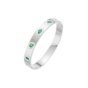 Macro view of silver titanium steel bracelet with emerald green stones and pavé diamonds