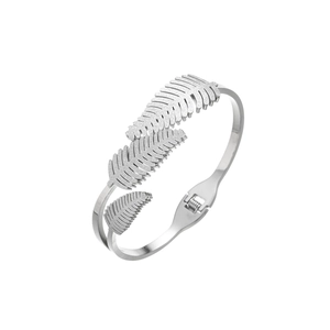 Macro shot of silver leaf-shaped bracelet with frosted texture and polished steel band