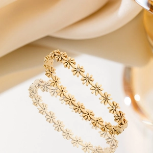 Elegant gold titanium steel daisy bracelet with sparkling crystal centers and mirror finish