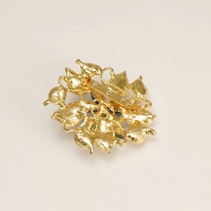 Back view of luxury gold-plated floral brooch with layered petals and secure pin clasp