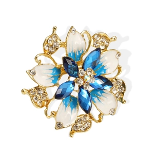 Luxury floral brooch with blue enamel petals and sparkling crystals on golden alloy
