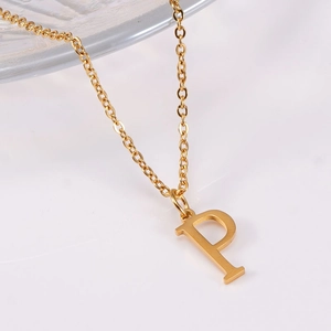 Macro detail of initial P pendant with brushed gold finish on a fine O-chain necklace