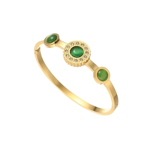 Vintage gold-plated cuff bangle with emerald green cat-eye stones and pavé zircons