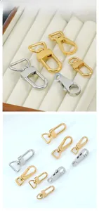 Detailed tile display of gold and silver swivel lobster clasps for bags and keychains