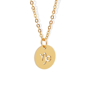 Detailed macro view of a gold-plated Capricorn zodiac hollow round pendant necklace