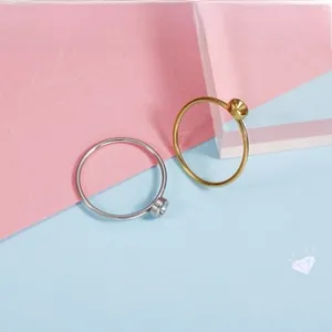 Detailed view of gold and silver stainless steel rings with empty round base for DIY gems
