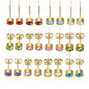 Detailed close-up of 12-month round-cut birthstone stud earrings in golden settings