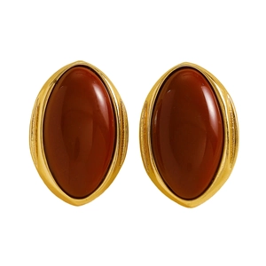 Detailed close-up of vintage oval resin stud earrings with a polished golden frame