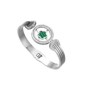 Silver steel bangle featuring a green clover stone with micro-pave crystals