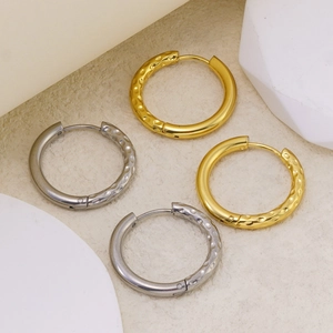 Minimalist geometric hoop earrings with textured hammered finish in gold and silver