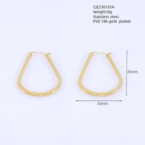 Detail of PVD 18k gold plated teardrop earrings in stainless steel with hammered texture