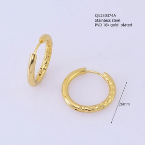Detail of 26mm stainless steel gold plated earrings with hammered and polished texture