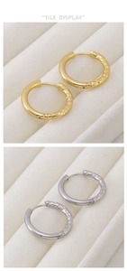 Detail view of gold and silver hoop earrings with hammered texture on white velvet stand