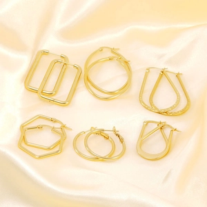 Set of six pairs of gold geometric hoop earrings with polished mirror finish for women