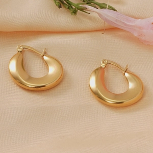 Detailed close-up of 18K gold-plated stainless steel chunky hoop earrings on silk fabric