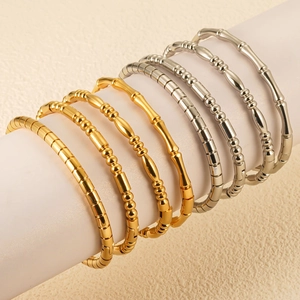 Detailed view of bamboo style stacking bracelets in polished gold and silver finishes