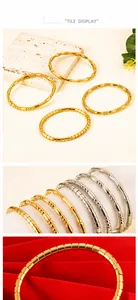 Detailed close-up of 18K gold plated bamboo and textured stainless steel bangle set