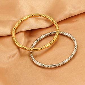 Bamboo style 18K gold and silver plated stainless steel bracelets on gold silk fabric