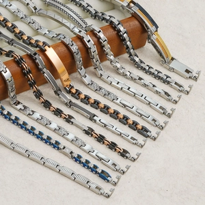 Multi-color stainless steel watchband bracelets for men and women on a wooden display stand