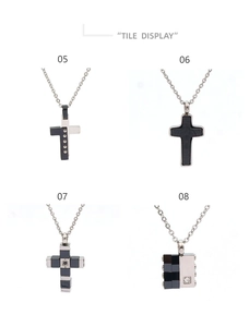 Detail display of four cross and geometric stainless steel pendants with rhinestones