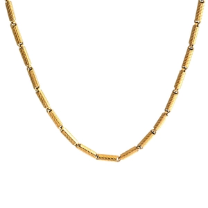 18K gold plated bamboo link necklace with textured cylindrical metal beads on white background