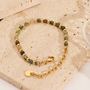 Detail of 18K gold stainless steel bracelet with natural colorful stone beads on stone