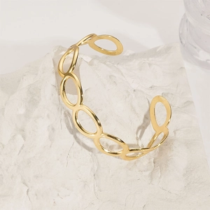 Detailed macro of gold plated stainless steel open bangle with hollow oval link design