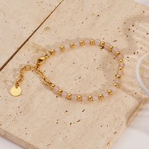 Detail of 18K gold stainless steel bracelet with soft pink beads and lobster clasp