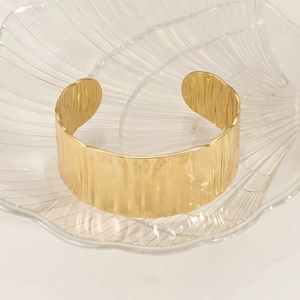 Golden stainless steel open cuff bracelet with water ripple texture in shell tray