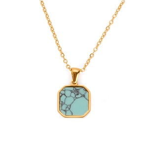 Macro shot of gold octagonal necklace pendant with turquoise stone and fine chain