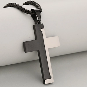 Two-tone silver and black stainless steel cross pendant with textured diagonal stripes