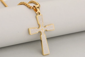 Detail of 18k gold plated stainless steel cross pendant with engraved Lord’s Prayer