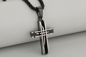 Close-up of dual-tone stainless steel cross pendant with hollow layered mesh texture