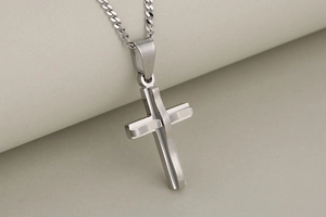 Polished silver double-layered stainless steel cross pendant on a classic cuban chain