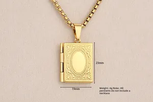 Detailed macro view of a vintage gold book locket showing 23mm by 19mm dimensions